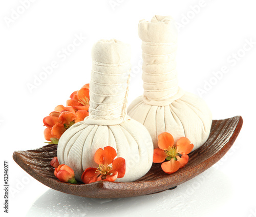 Photo: Herbal compress balls for spa treatment and flowers isolated Herbal compress balls for spa treatment and flowers isolated