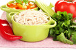 Shredded boiled chicken in green pan close up