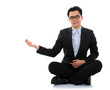 Photo: Asian business man showing blank space sit on floor Asian business man showing blank space sit on floor