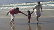 Happy family having fun on the beach, super slow motion