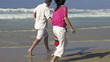 Happy family having fun on the beach, super slow motion