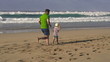 Father, son and joggers on the beach, super slow motion