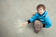 Boy drawing on road