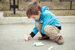Photo: Boy drawing on road Boy drawing on road