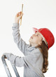 girl in the construction helmet with a brush.
