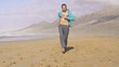 Man jogging on beautiful beach, super slow motion, 240fps