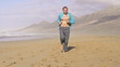 Young man jogging on beautiful beach