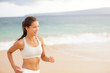 Athletic young woman running on the beach