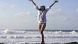 Happy, excited woman standing by the sea