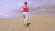 Young woman jogging on beautiful beach