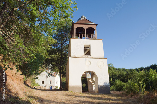 white belltower of Sveti Petar i Pavle in Ljubojno near Lake Prespa, Republic of Macedonia 