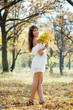  girl in white dress at autumn park