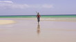 Woman jogging on beautiful beach, super slow motion, 240fps