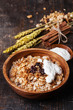 Muesli granola with raisin and yogourt in wooden bowl