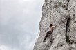 Young man climbing on limestone wall