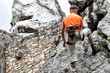 Young man climbing on limestone wall