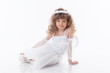 Photo: Smiling young girl posing in angel costume Smiling young girl posing in angel costume