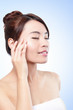 beautiful face of girl applying moisturize cream