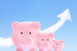 Photo: pink piggy banks with sky and cloud arrow pink piggy banks with sky and cloud arrow