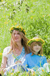 mother and son with flower wreaths