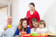  family having tea with cakes at home  together