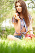 Beautiful woman in the garden with apples