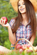 Beautiful woman in the garden with apples