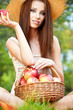 Beautiful woman in the garden with apples