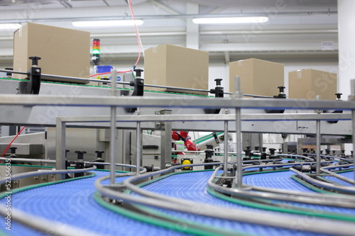 Photo: Cardboard boxes on conveyor belt in factory Cardboard boxes on conveyor belt in factory