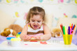 Little kid playing with colorful clay
