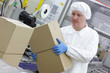 manual worker at production line dealing with boxes