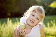 Blonde girl eating apple