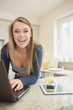 Photo: Laughing woman at laptop with smart phone and tablet Laughing woman at laptop with smart phone and tablet