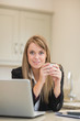 Photo: Smiling woman with laptop Smiling woman with laptop