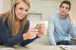 Photo: Woman texting while man calling Woman texting while man calling