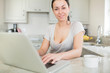 Photo: Smiling woman using laptop Smiling woman using laptop