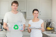 Couple holding recycling bin and newspapers