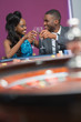 Couple sitting clinking glasses at the roulette table
