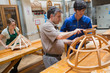 Teacher helping a student in a woodwork class