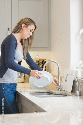 Photo: Woman doing the washing up Woman doing the washing up
