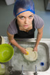 Woman looking up from doing the washing up