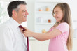 Daughter fixing fathers tie