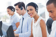 Photo: Smiling agent with colleagues sitting Smiling agent with colleagues sitting