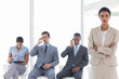 Businesswoman standing in front of business people