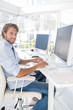 Happy designer working at his desk