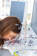 Editor using magnifying loupe to view the contact sheet