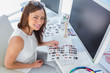 Smiling designer holding contact sheet
