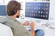 Photo: Photo editor looking at thumbnails on computer Photo editor looking at thumbnails on computer