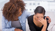 Sad woman crying next to her therapist