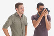 Photo: Stylish man watching his friend taking a picture Stylish man watching his friend taking a picture